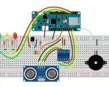 Schema di prototipazione per progetti Arduino per auto: sensore ultrasuoni, LED, buzzer e transistor su breadboard.