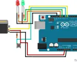 Schema di collegamento con servo, due LED, un pulsante e Arduino Uno. Il servo è collegato a un pin digitale.