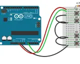 Un pin Arduino collegato a una breadboard con quattro pulsanti (S1-S4) e resistori.