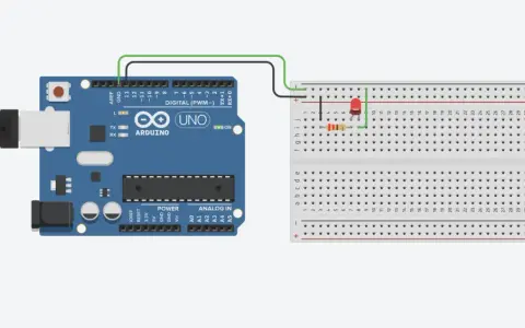Un Arduino UNO collegato via USB a un computer, con un LED e un resistore connessi a una breadboard cos'è, per creare un circuito semplice.