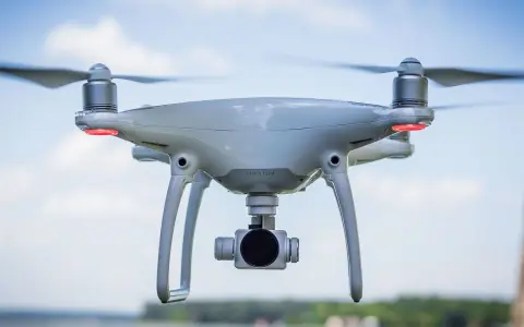 Un drone bianco con quattro eliche in movimento, pronto a catturare immagini aeree.
