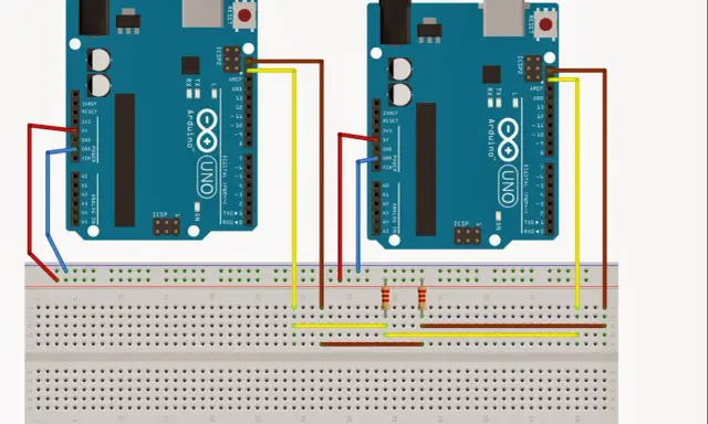 Due Arduino Uno collegati tramite i2c: uno master e uno slave, con fili rossi, gialli e marroni su breadboard.